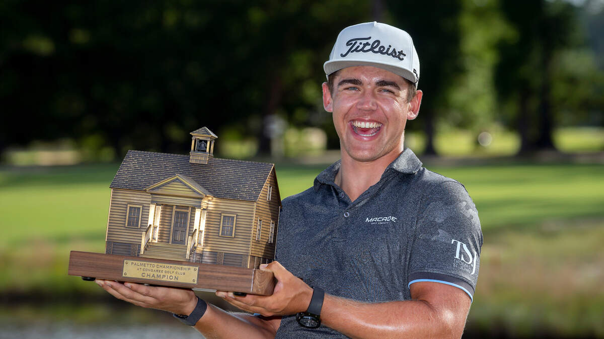 Garrick Higgo, of South Africa, holds the championship trophy after winning the final round of the Palmetto Championship golf tournament in Ridgeland, S.C., Sunday, June 13, 2021. (AP Photo/Stephen B. Morton)