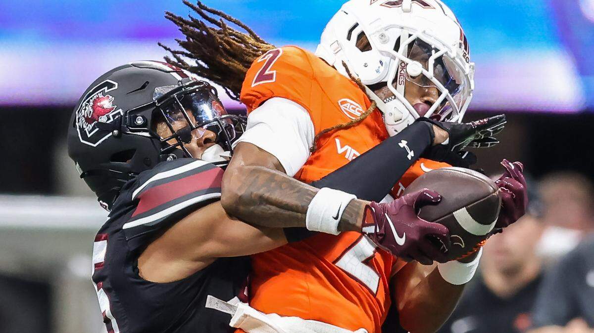 South Carolina defensive back Brandon Cisse (15) tries to break up the pass to Virginia Tech wide receiver Takye Heath (2) on Sunday at Mercedes-Benz Stadium in Atlanta. The Gamecocks and Hokies faced off Aug. 31 in the 2025 Aflac Kickoff Game.