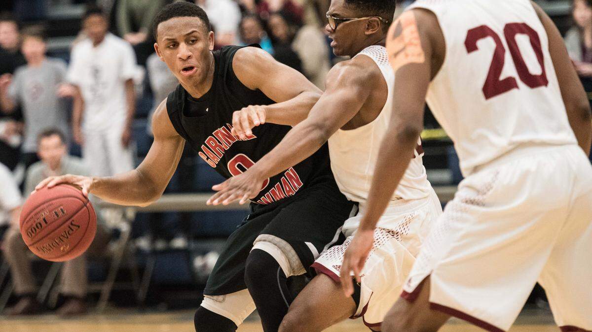 Brandon Martin dribbles the ball during a Cardinal Newman game in 2017.