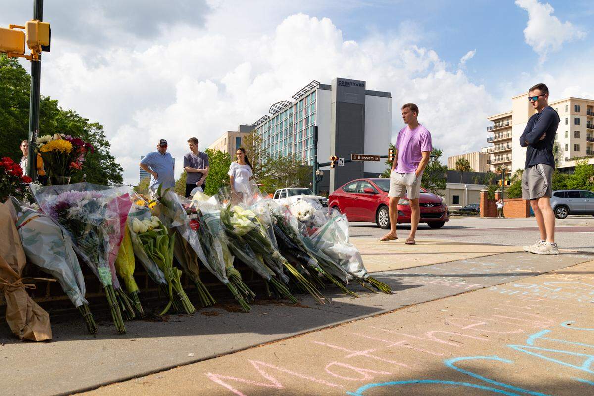 South Carolina students leave messages and flowers at a memorial for South Carolina student Nate Baker, who died after a hit-and-run crash on the intersection of Blossom Street and Assembly Street on Friday, April 4, 2025.