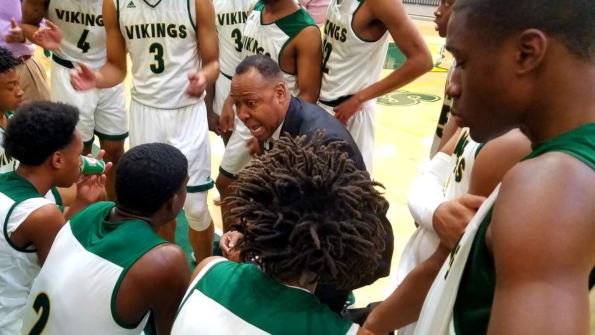 Spring Valley coach Perry Dozier talks to his team during a timeout of Wednesday’s 5A first-round playoff game against Byrnes. The Vikings won. 52-48.