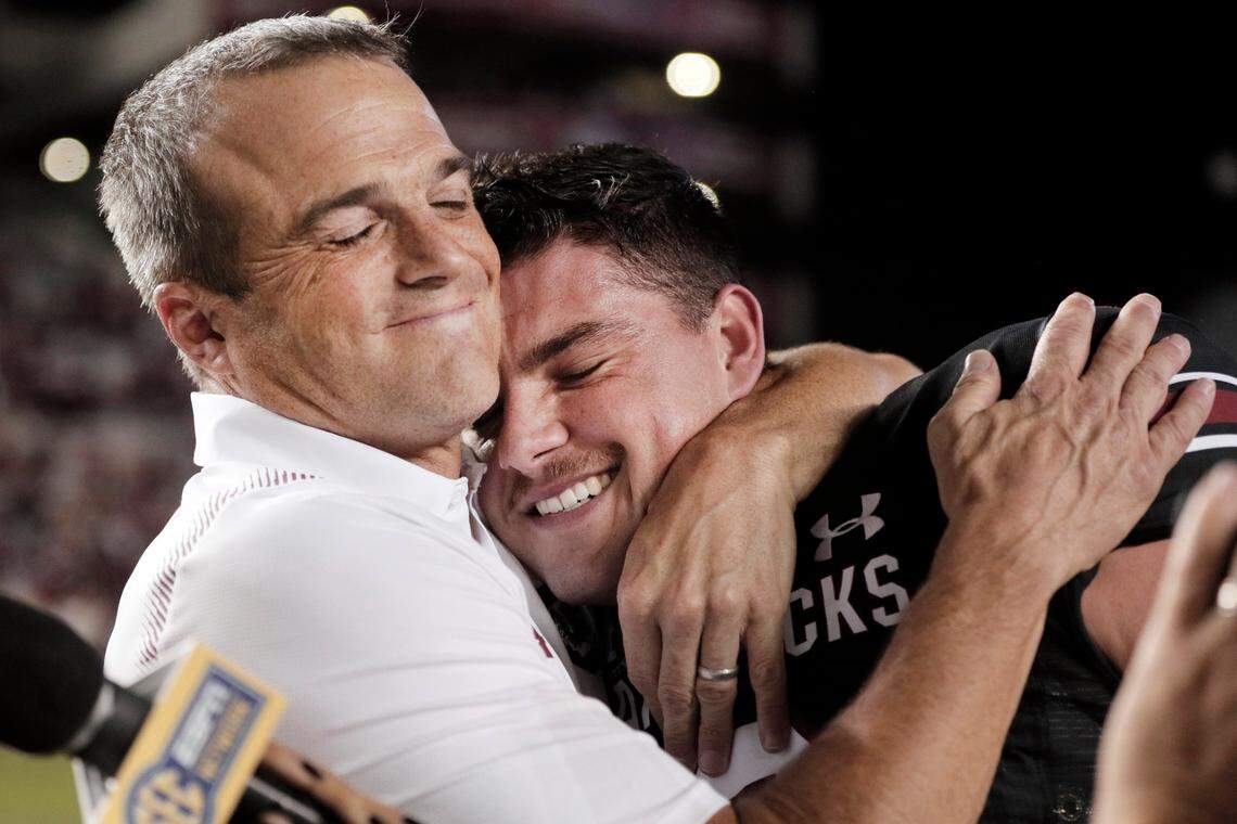 South Carolina Gamecocks head coach Shane Beamer embraces South Carolina Gamecocks quarterback Zeb Noland (8) after defeating Vanderbilt at Williams-Brice Stadium on Saturday, October 16, 2021.