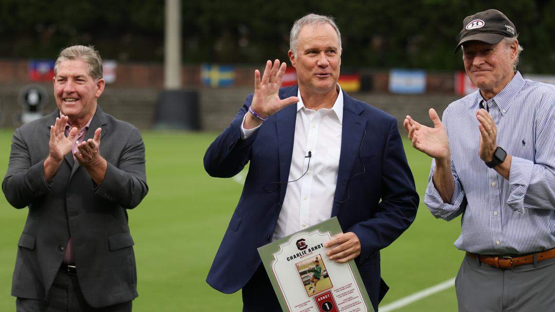 Charlie Arndt stands alongside Ray Tanner (left) and former USC coach Mark Berson (right) during his jersey retirement ceremony.