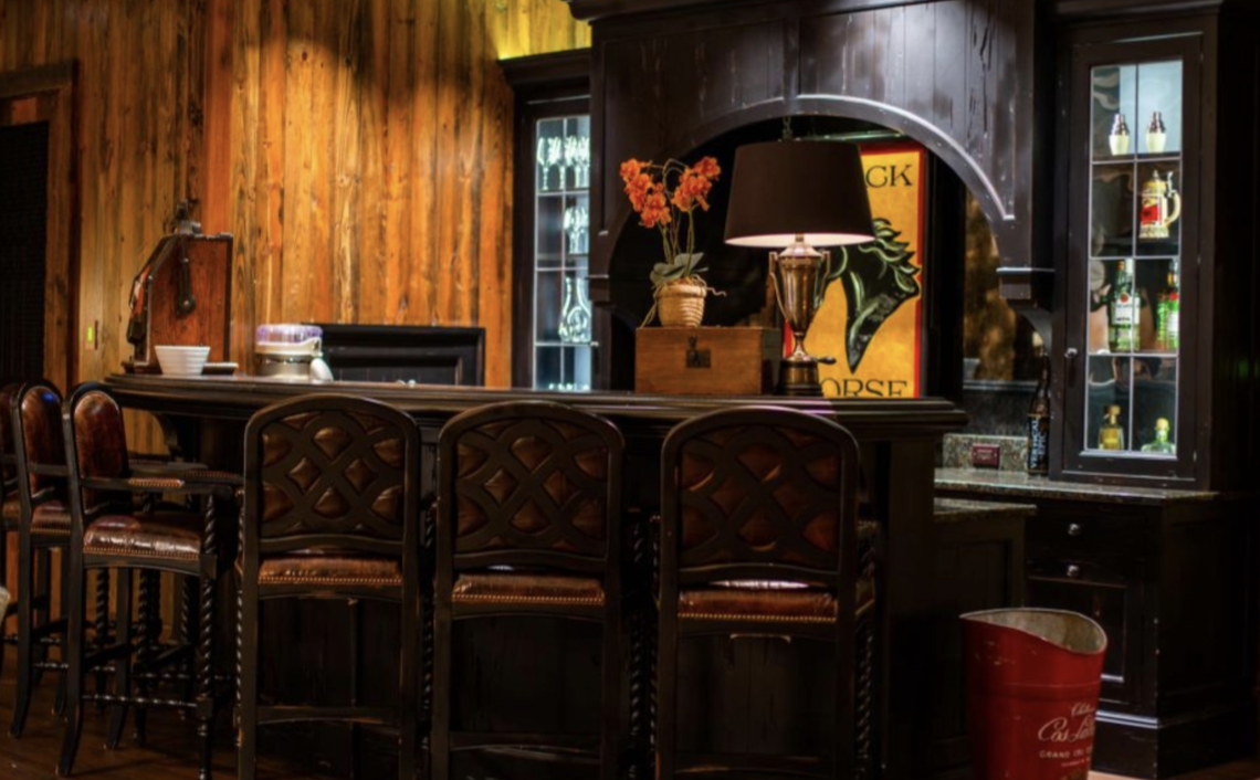 The house, which is being sold with the furnishings and artwork, includes a home theater, a pub-style bar, gym, seven bathrooms, four powder rooms and a wine room.