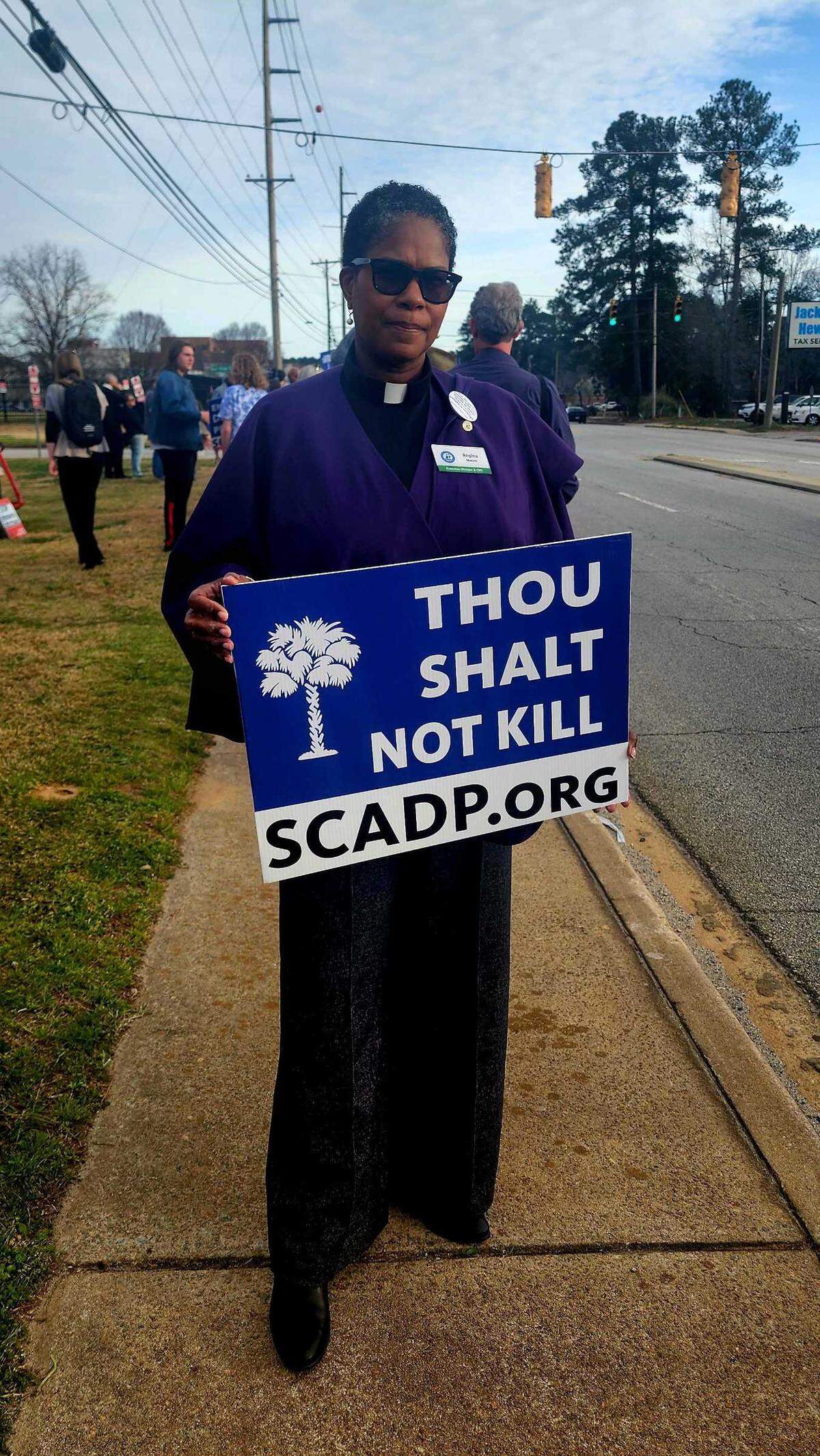 Rev. Dr. Regina Moore of the Methodist Church in Columbia, stands alongside Broad River Road in front of the Broad River Correctional Institution in protest of Brad Sigmon’s execution.