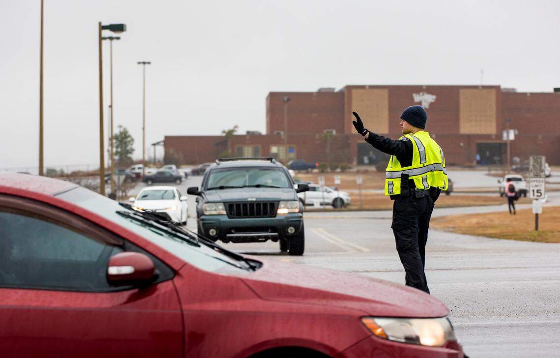 A Lexington County Sheriff’s deputy directs traffic outside White Knoll High School as parents and guardians pick up students Thursday morning after students were sent home due to a threat to the school and several others in the area Feb. 2, 2023.