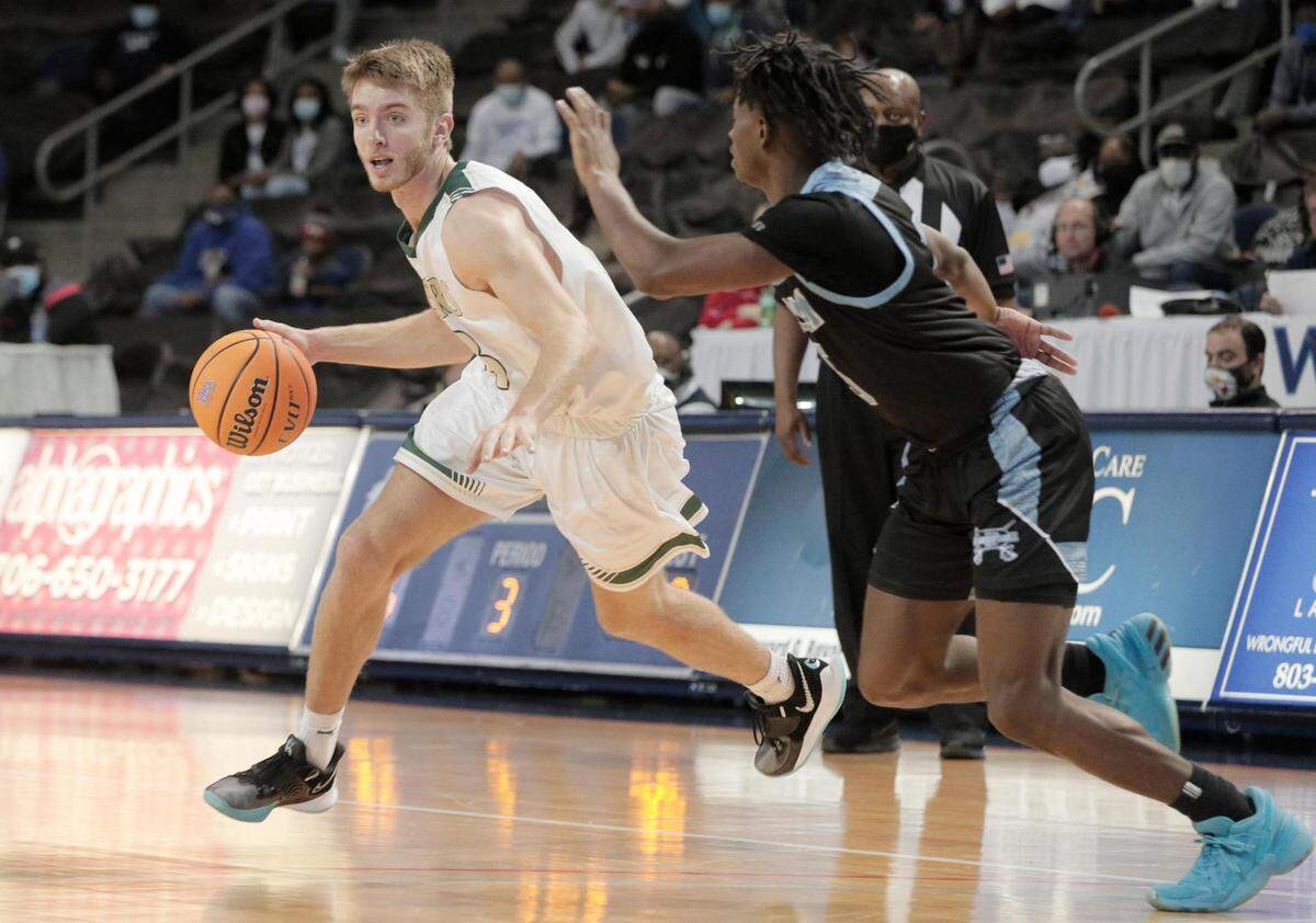 Dorman’s Davison Wright 5 attempts to guard River Bluff’s Malachi Reeves 33 in Aiken, South Carolina on Saturday, March 6, 2021.