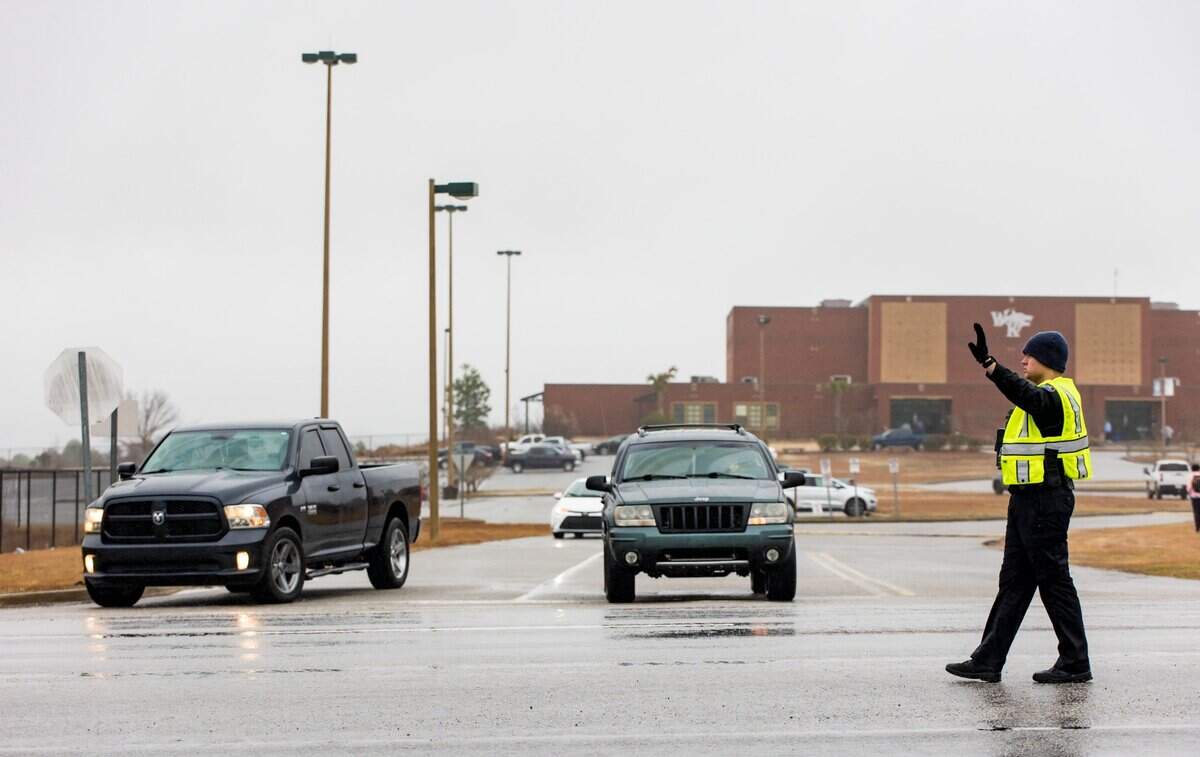 A Lexington County Sheriff’s deputy directs traffic outside White Knoll High School as parents and guardians pick up students Thursday morning after students were sent home due to a threat to the school and several others in the area Feb. 2, 2023.