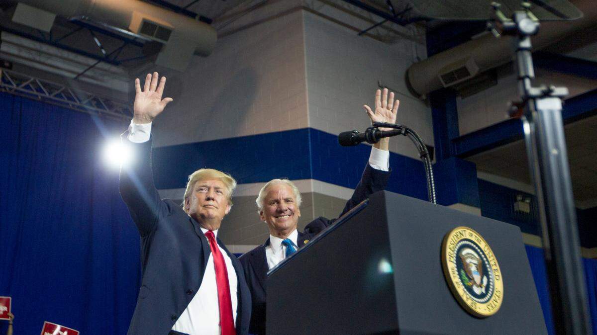 President Donald Trump and South Carolina Gov. Henry McMaster wave to the crowd during an event at Airport High School on Monday, June 25, 2018, in West Columbia, South Carolina.
