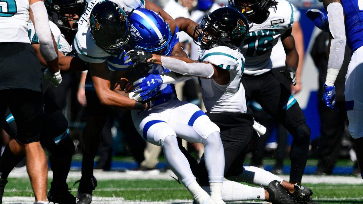 Georgia State’s Jamyest Williams is tackled by Coastal Carolina linebacker Isaiah Stephens, left, and Coastal Carolina cornerback Manny Stokes Jr., right, during the second half of an NCAA football game Saturday, Oct. 31, 2020, in Atlanta. Coastal Carolina won 51-0. (AP Photo/John Amis)