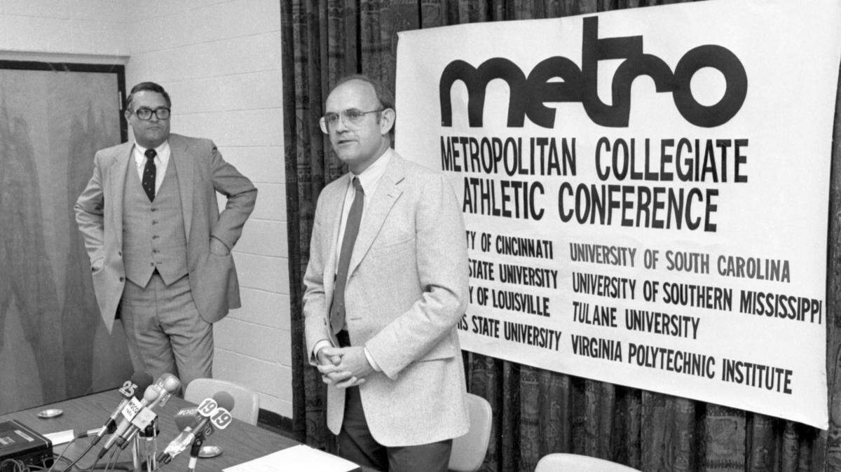 April 14, 1983: USC announces its entry into the Metro Conference: University of South Carolina athletic director Bob Marcum announces that the Gamecocks will join the Metropolitan Collegiate Athletic Conference at a USC Board of Trustees meeting. Metro Conference commissioner Jerry Lovelace stands by.