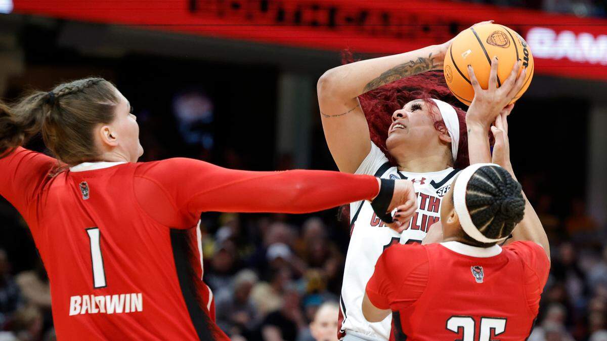 South Carolina’s Kamilla Cardoso (10) looks to shoot as NC State’s River Baldwin (1) and Zoe Brooks (35) pressure during the Final Four game at Mortgage FieldHouse in Cleveland, Ohio on Friday April 5, 2024.