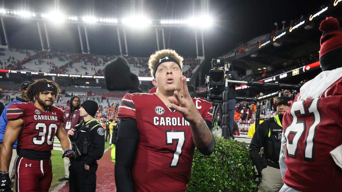 South Carolina quarterback Spencer Rattler (7) tosses a glove to a fan as he walks off the field following South Carolina’s game against Clemson at Williams-Brice Stadium in Columbia on Saturday, November 25, 2023.