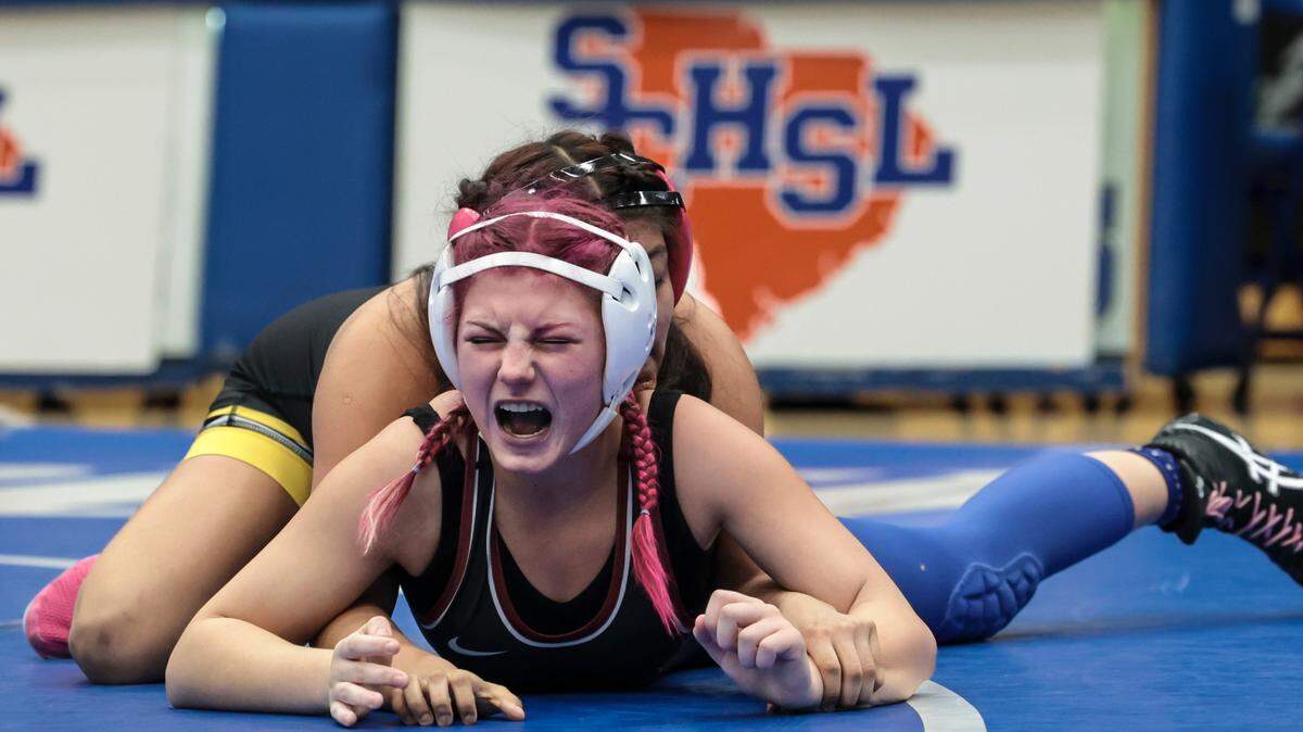 In the 125 pound weight class, Rock Hill’s Kennedy Thompson reacts as Greenwood’s Guadalupe Jose makes a move during the Class 5A state championships at Dreher High School on Saturday, Feb. 8 2025.