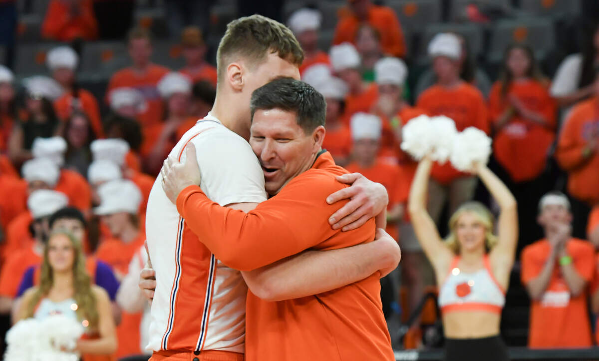Mar 8, 2025; Clemson, SC, USA; Clemson Head Coach Brad Brownell hugs Clemson sophomore center Viktor Lakhin (0) during the pregame senior night presentation, before tipoff at Littlejohn Coliseum in Clemson, S.C Saturday, March 8, 2025.