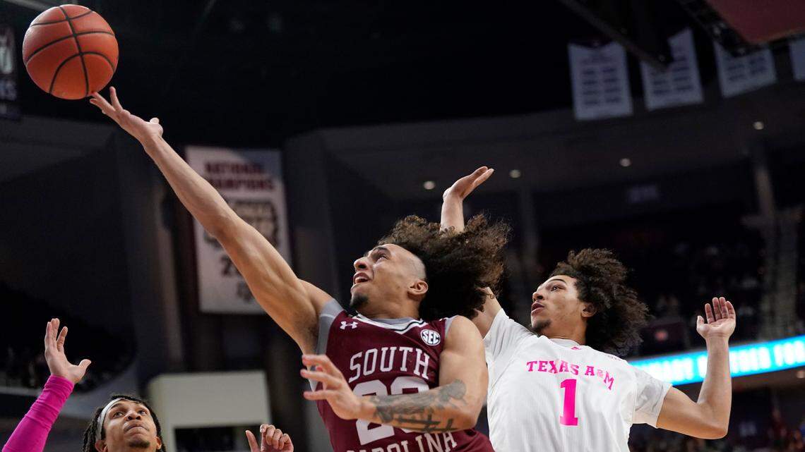 South Carolina guard Devin Carter (23) drives past Texas A&M guard Marcus Williams (1) for a basket during the second half of an NCAA college basketball game Saturday, Jan. 29, 2022, in College Station, Texas.
