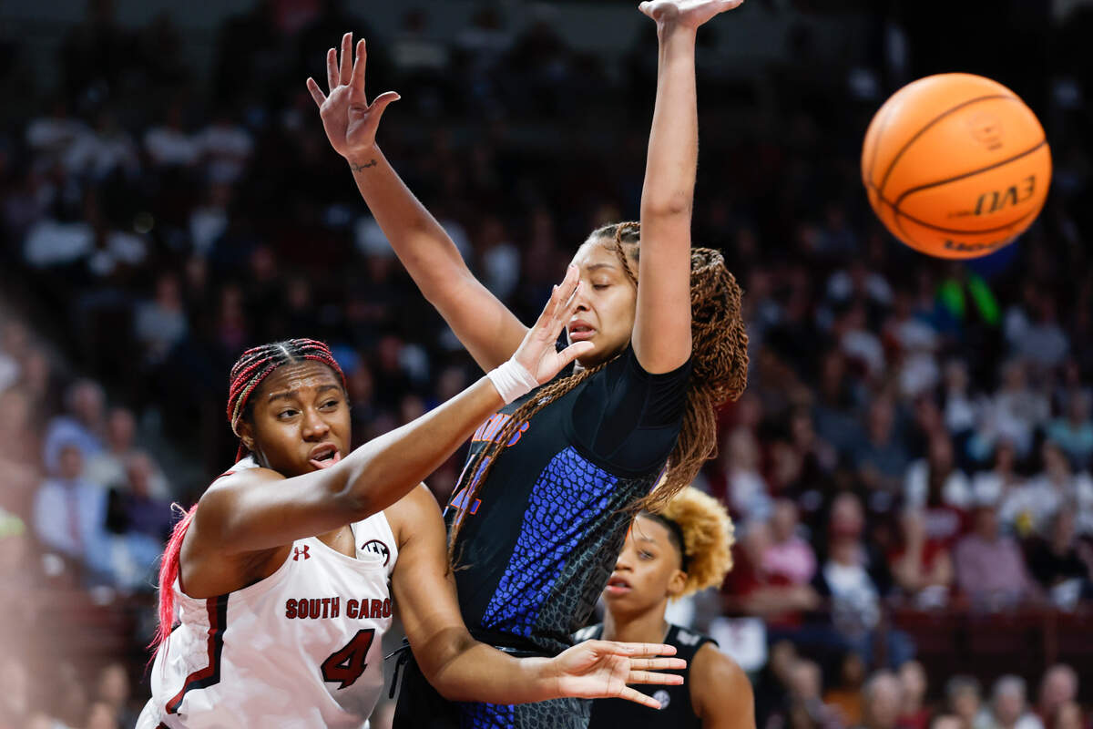 South Carolina forward Aliyah Boston, left, passes the ball around Florida center Ra Shaya Kyle during the first half of an NCAA college basketball game in Columbia, S.C., Thursday, Feb. 16, 2023. (AP Photo/Nell Redmond)