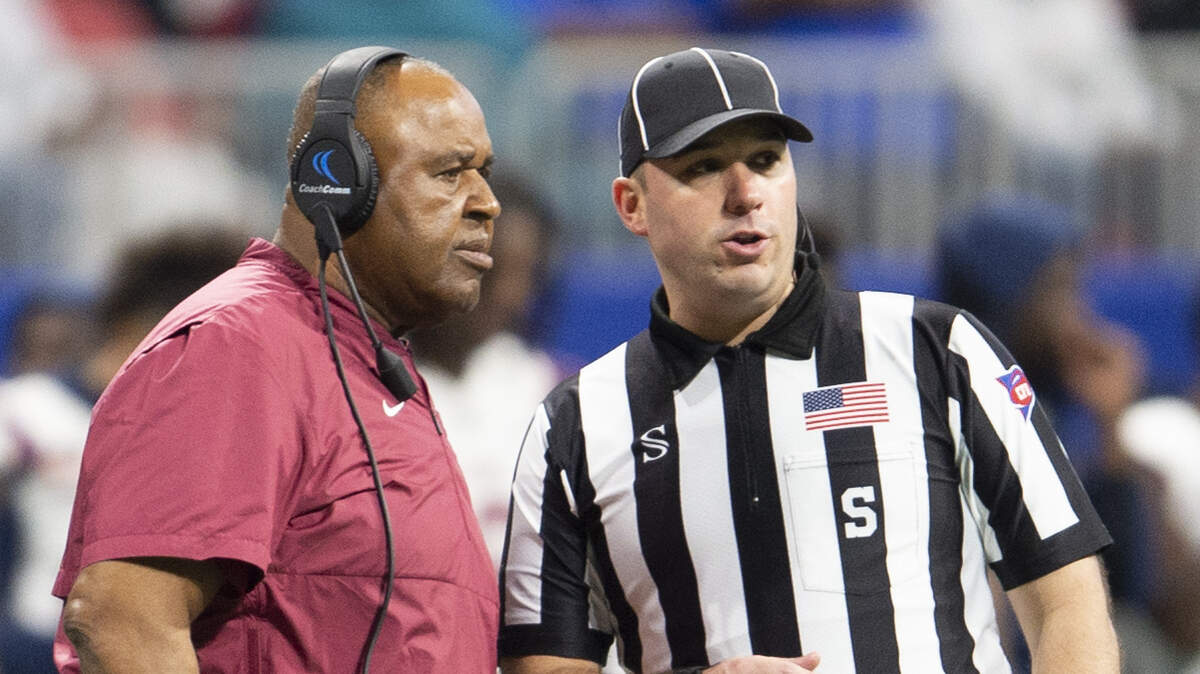 South Carolina State head coach Buddy Pough speaks with a referee during the Cricket Celebration Bowl game against Jackson State on Saturday in Atlanta.