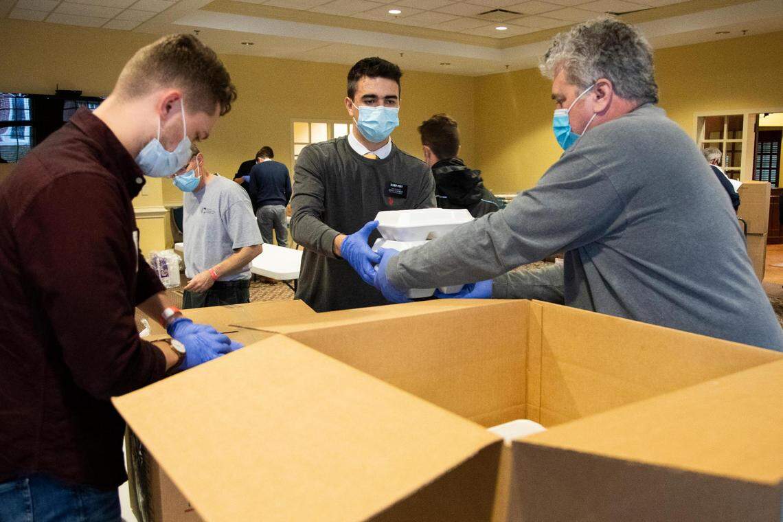 Members of churches across Columbia pack up Thanksgiving lunches for delivery to places across Columbia at The Basilica of St. Peter in downtown Columbia, South Carolina on Thursday, November 26, 2020. Hundreds of meals were delivered across the city.