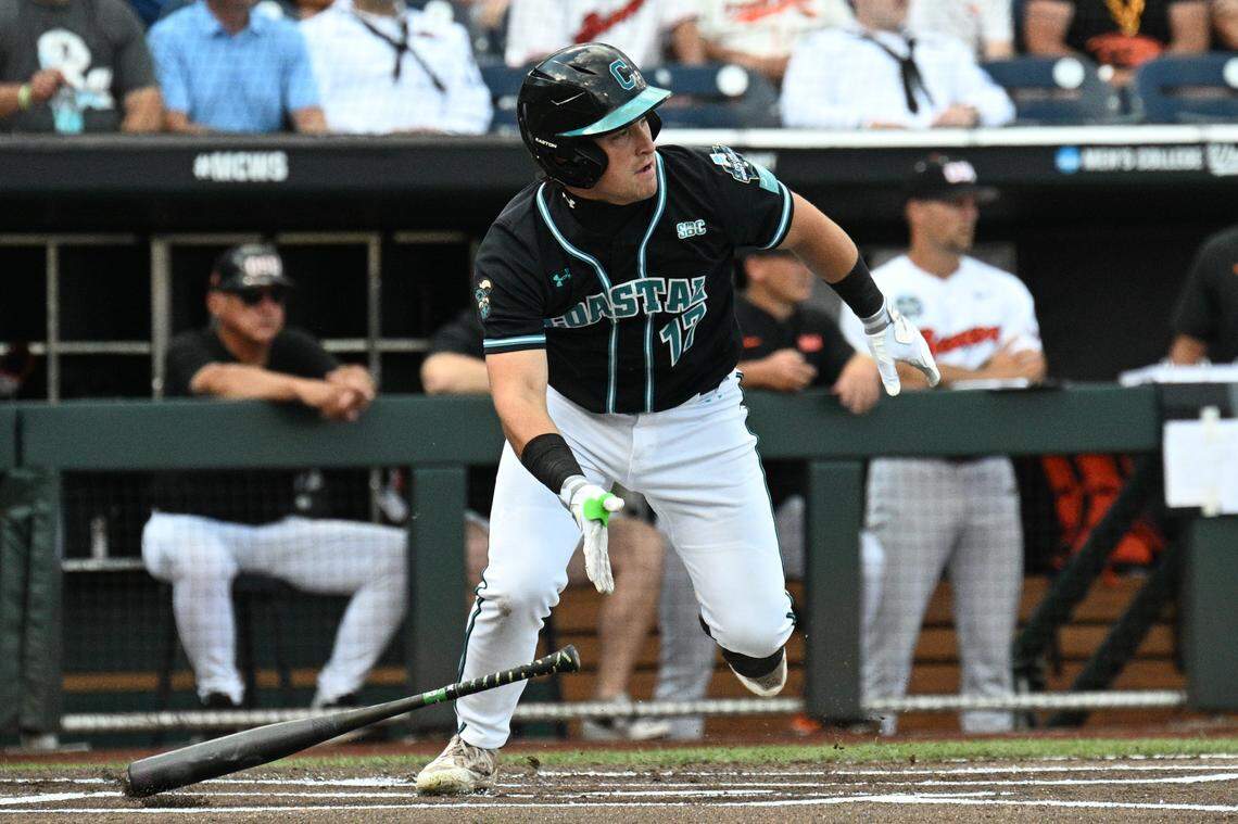 Coastal Carolina Chanticleers catcher Caden Bodine (17) reaches on an infield error by the Oregon State Beavers during the first inning at Charles Schwab Field.