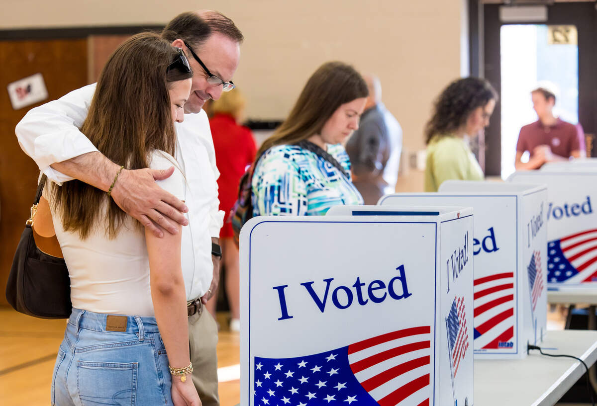 Attorney General Alan Wilson, Republican candidate for governor, hugs his daughter, Anna Grace Wilson, 17 after voting at New Providence Elementary School in Lexington, S.C., on Tuesday morning.