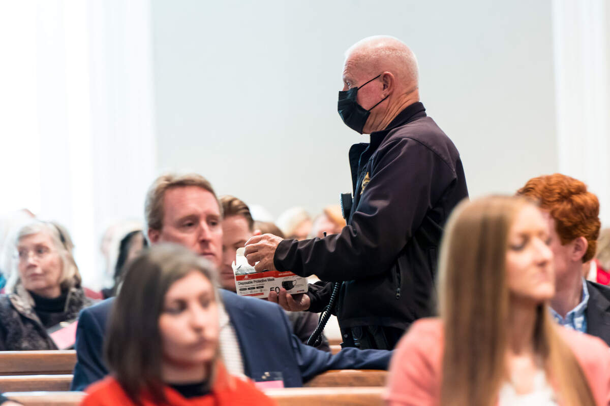 A Colleton County Sheriff’s Deputy hands out masks during day 16 of the double murder trial of Alex Murdaugh at the Colleton County Courthouse on Monday, Feb. 13, 2023. Jeff Blake/The State/Pool