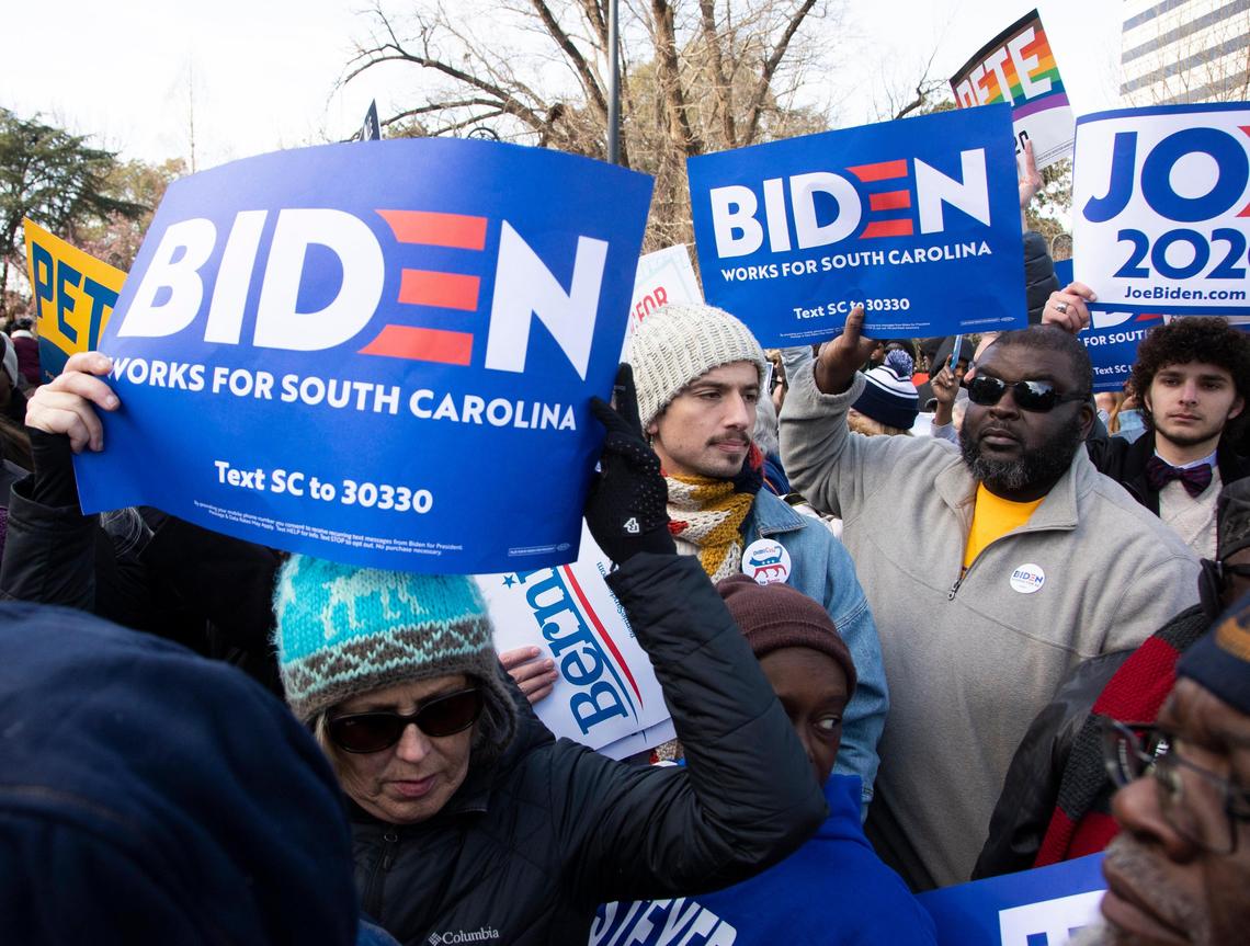 Suportters hold candidate signs at the King Day at the Dome Martin Luther King Day celebration at the South Carolina statehouse on Monday, January 20, 2020.