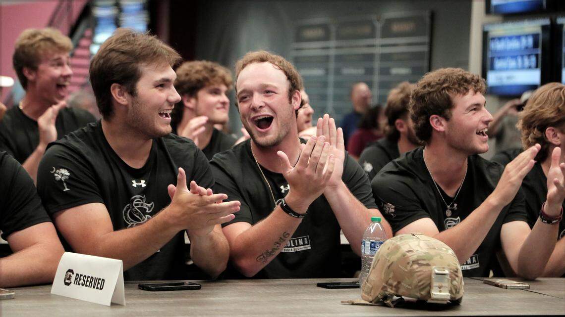 South Carolina baseball players Cade Austin (from left), Jackson Phipps and James Hicks react as the Gamecocks’ regional is revealed during a selection show watch party inside the Cookaboose Club in Williams-Brice Stadium on Monday, May 29.