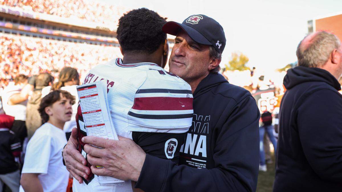 South Carolina quarterback LaNorris Sellers (16) is congratulated by offensive analyst Mike Shula after defeating Clemson in the Palmetto Bowl between at Memorial Stadium in Clemson on Saturday, November 30, 2024.