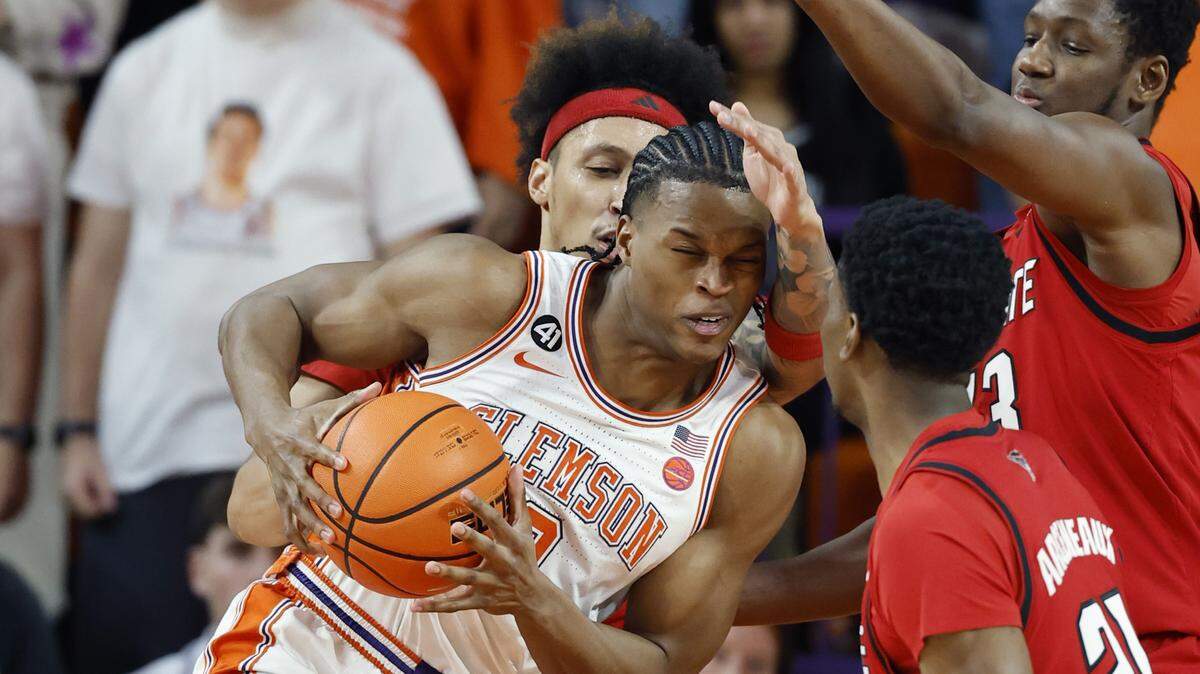 N.C. State's Darrion Williams (1) defends Clemson's RJ Godfrey (0) during the first half of N.C. State’s game against Clemson at Littlejohn Coliseum in Clemson, S.C., Tuesday, Jan. 20, 2026.