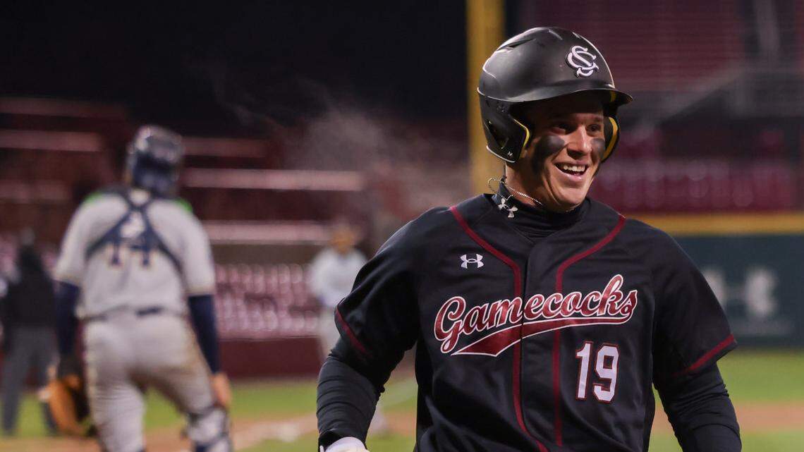 South Carolina infielder KJ Scobey (19) smiles after scoring during the Gamecocks’ game against Queens University at Founders Park in Columbia on Wednesday, February 19, 2025.