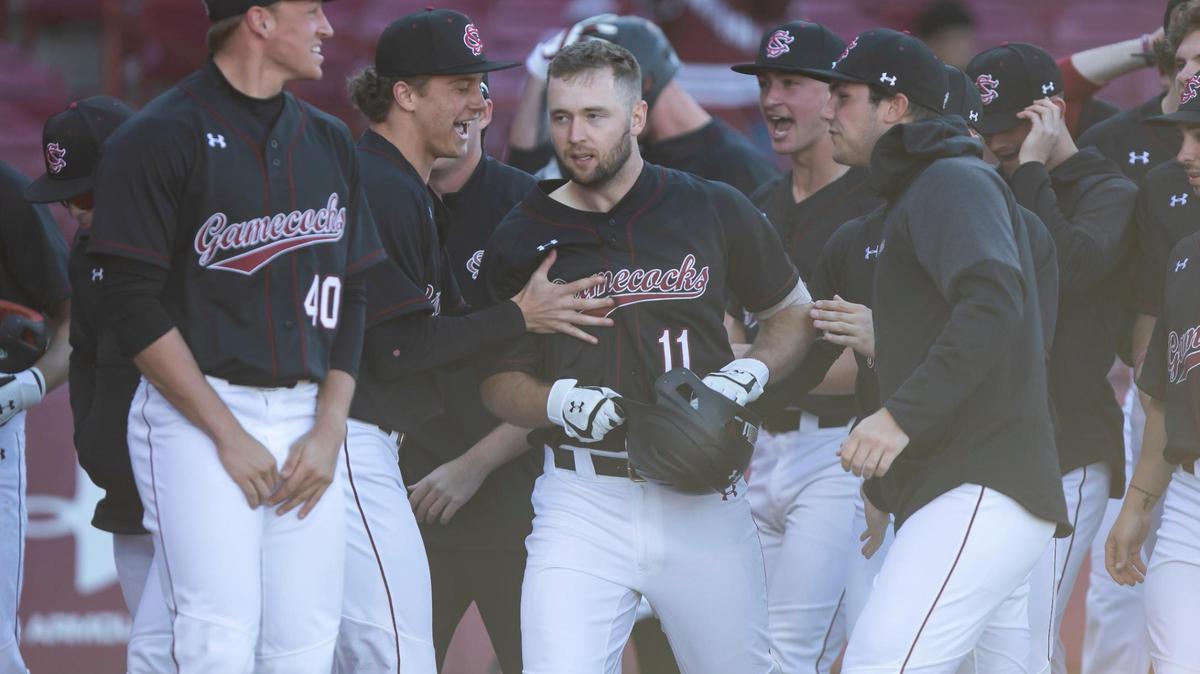 Players celebrate after Andrew Eyster hit a grand slam in the bottom of the 9th inning to tie the game during the Gamecocks’ game against UNC Greensboro at Founders Park on Sunday, February 20, 2022.