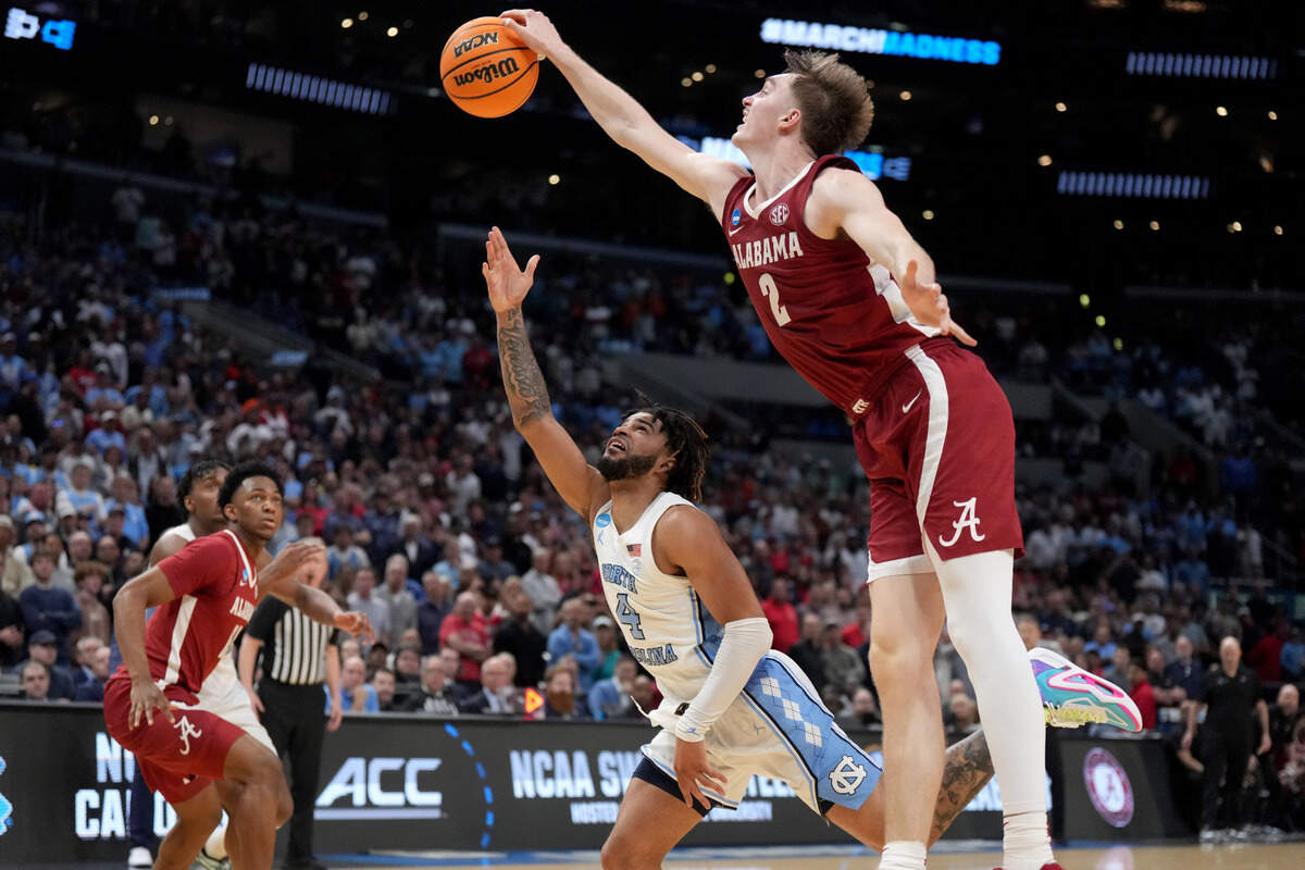 Mar 28, 2024; Los Angeles, CA, USA; Alabama Crimson Tide forward Grant Nelson (2) blocks North Carolina Tar Heels guard RJ Davis (4) in the second half in the semifinals of the West Regional of the 2024 NCAA Tournament at Crypto.com Arena.