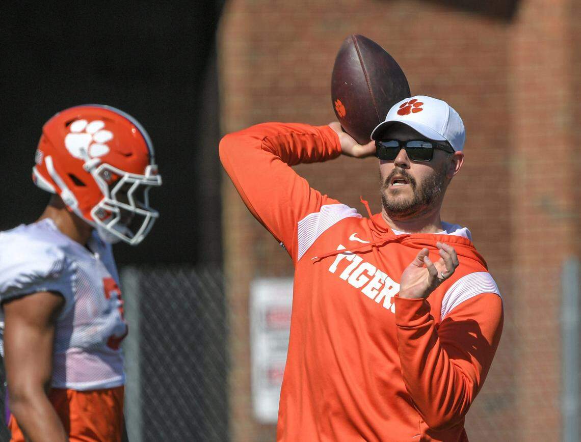 Clemson offensive coordinator Garrett Riley throws a ball during practice in Clemson in Clemson, S.C. March 29, 2023.