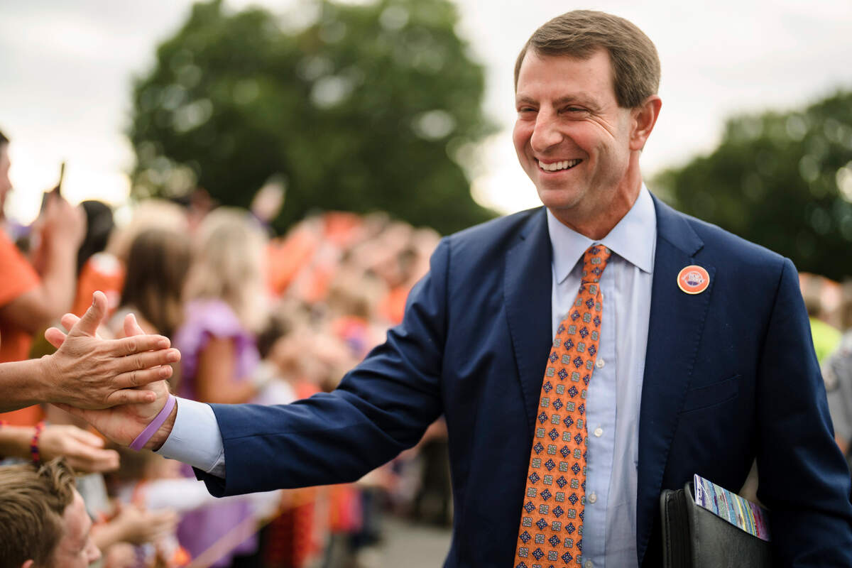 Clemson head coach Dabo Swinney greets fans as he walks toward the stadium before an NCAA college football game against North Carolina State, Saturday, Oct. 1, 2022, in Clemson, S.C.