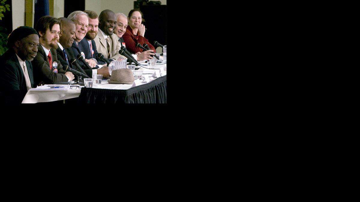 Columbia's mayoral candidates on Thursday share a laugh during a debate. From left, Nammu Muhammad, Aaron Johnson, Steve Benjamin, Steve Morrison, Kirkman Finlay, Irwin Wilson, Joseph Azar and Sparkle Clark.