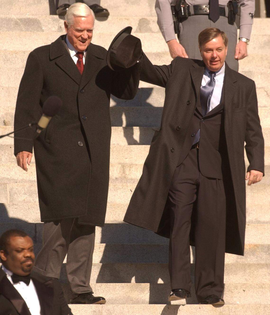 Sen. Lindsey Graham, right, raises the arm of Sen. Fritz Hollings to acknowledge the applause of the audience before Marshall Clement Sanford Jr. took the oath of office at 12:09 p.m. Wednesday to become the 115th governor of the state of South Carolina. Sanford, 42, was sworn in by S.C. Supreme Court Chief Justice Jean Toal on the south steps of the State House in front of family and friends and an audience estimated at 6,000 to 7,000 people. Erik Campos/The State