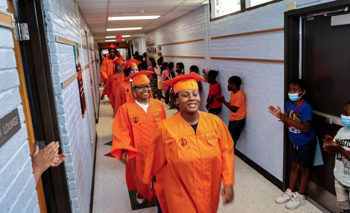 Seniors from Eau Claire High School take part in a school tradition where they walk the hallways of the middle and elementary schools they attended on the way to high school. Here, students at Gibbes Middle School applaud the graduates.