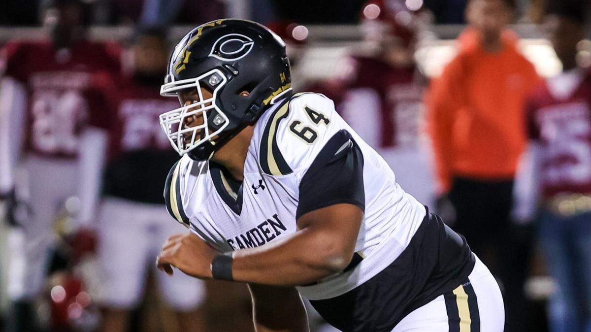 Camden Bulldogs defensive lineman Xzavier McLeod (64) rushes the passer against the Brookland-Cayce Bearcats in a playoff game Friday, Nov. 19, 2021 at Brookland-Cayce High School in Cayce, SC.