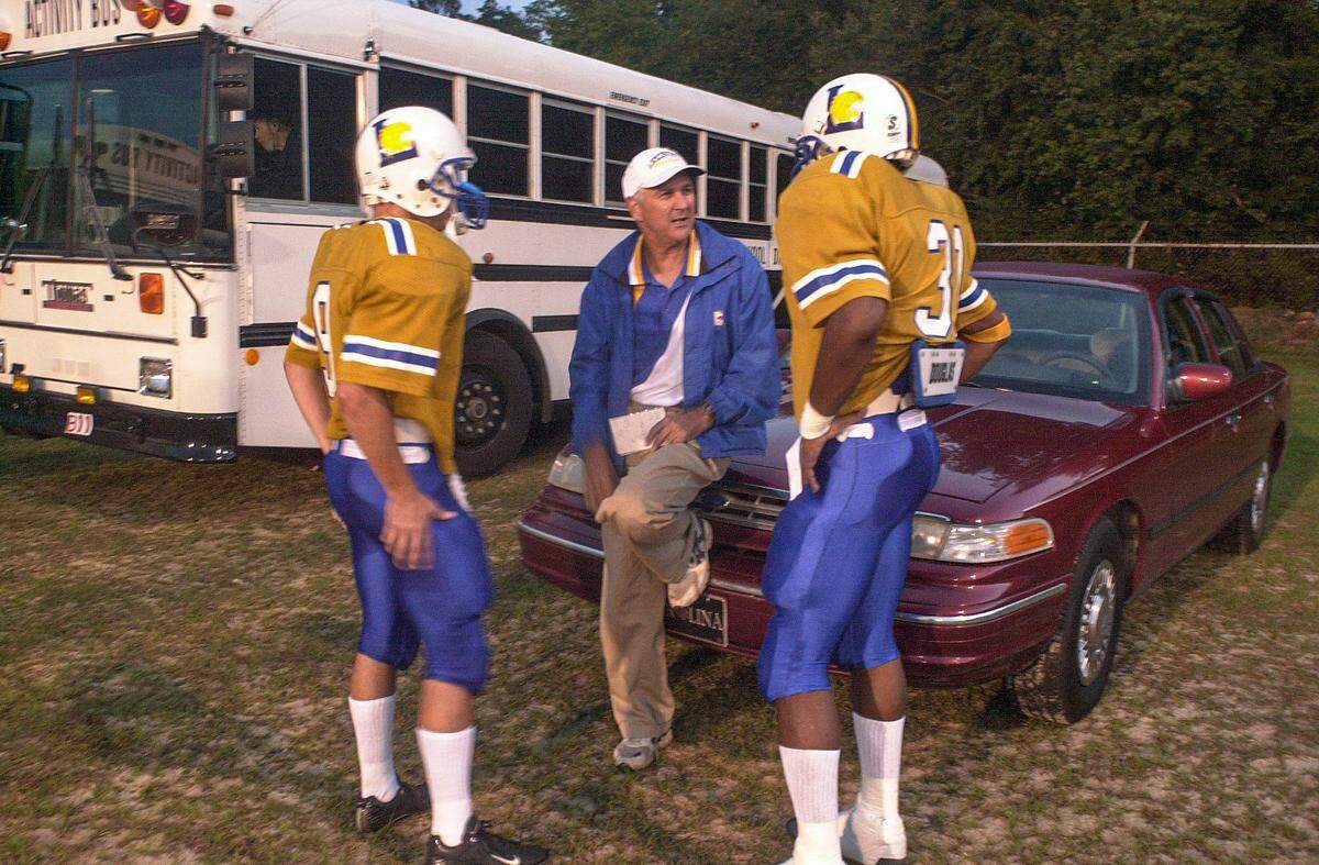 The late Jimmy Satterfield was a father figure for Demetris Summers and arguably his biggest mentor and supporter. Satterfield, then Lexington High School’s football coach, is shown here discussing plays with Summers, right, and quarterback Justin Pate before a game against North Augusta.