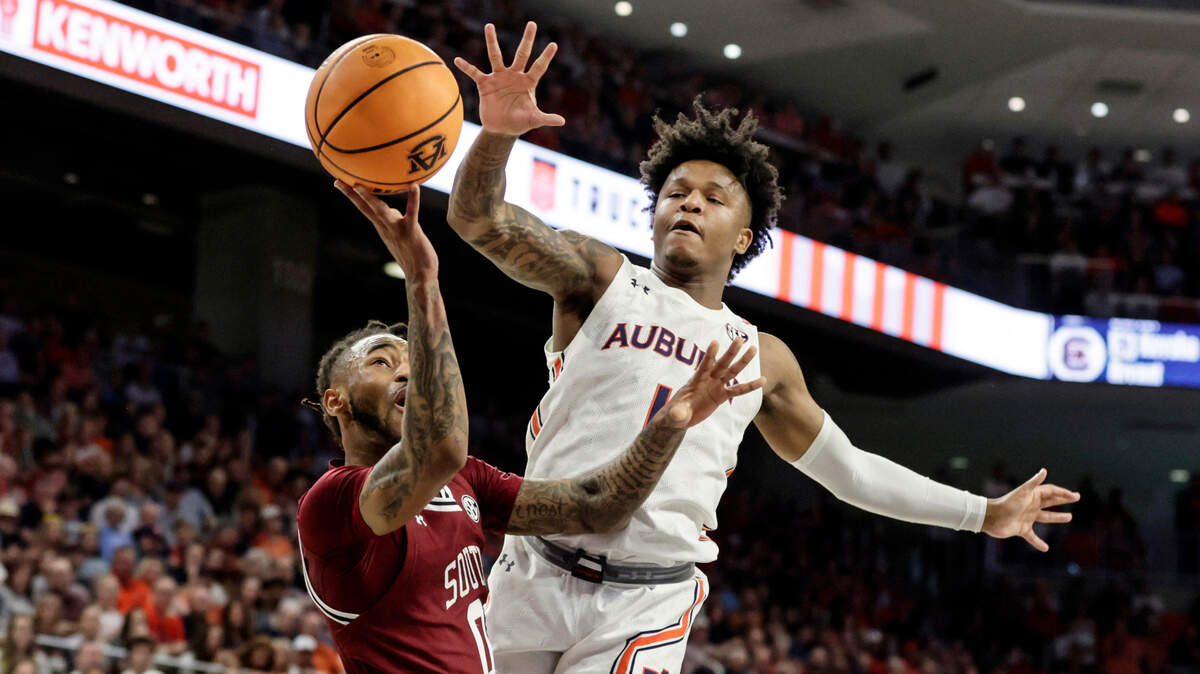 South Carolina guard James Reese V (0) is fouled by Auburn guard Wendell Green Jr. (1) as he goes up for a shot during the first half of an NCAA college basketball game Saturday, March 5, 2022, in Auburn, Ala. (AP Photo/Butch Dill)