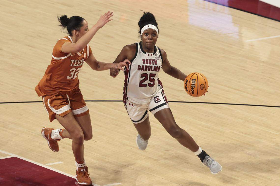 South Carolina's Raven Johnson (25) drives to the basket with Texas’s Teya Sidberry (32) during the first half of action of their women's basketball game against Texas at Colonial Life Arena on Thursday, Jan. 15, 2026.