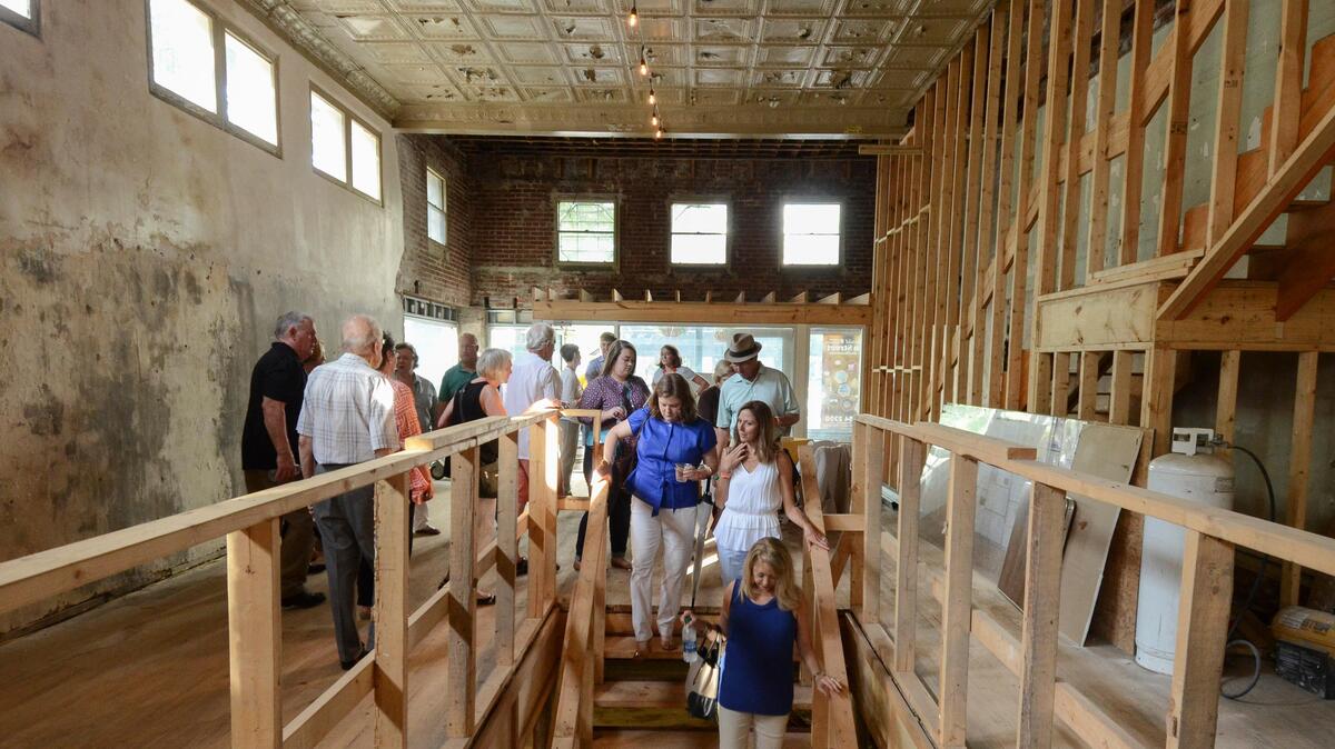 Guests take a behind-the-scenes tour of 1649 Main St., the future site of Hendrix restaurant.