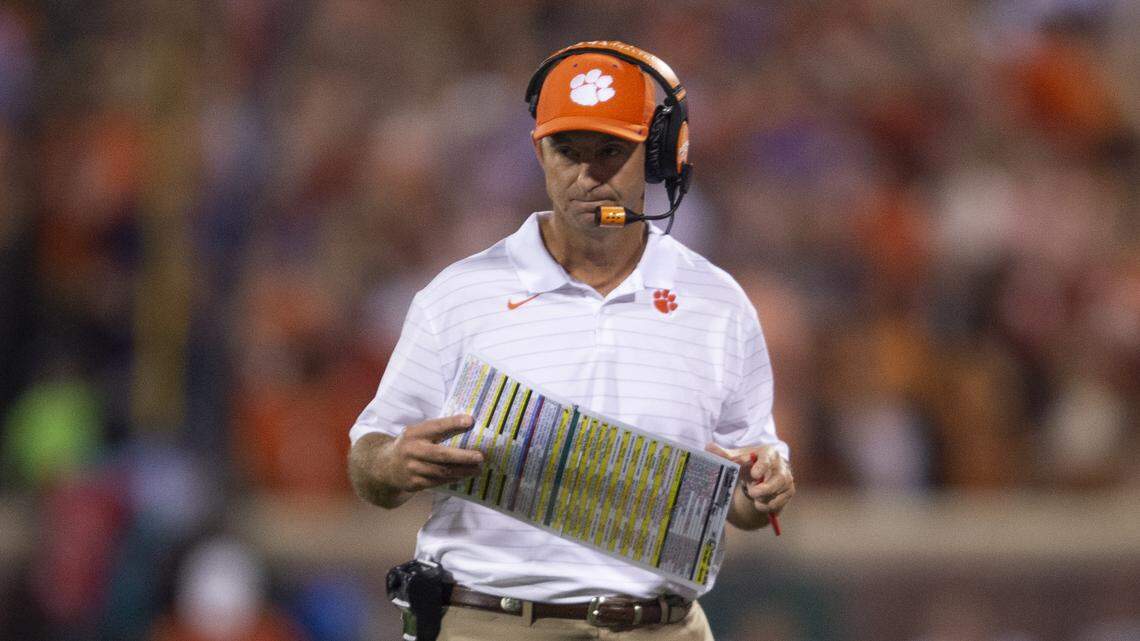 Clemson head coach Dabo Swinney looks at his play card during the first half of an NCAA college football game against Boston College Saturday, Oct. 2, 2021, in Clemson, S.C. (AP Photo/Hakim Wright Sr.)
