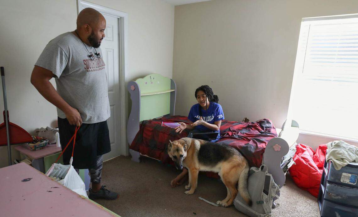 Shea Harley talks with his 14-year-old daughter Samara while she is at home while schools are closed due to the coronavirus. Samara and her twin brother Zion do their schoolwork in their rooms. 3/20/20