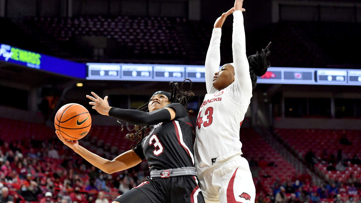 South Carolina guard Destanni Henderson (3) drives past Arkansas guard Makayla Daniels (43) to score during the first half of an NCAA college basketball game Sunday, Jan. 16, 2022, in Fayetteville, Ark. (AP Photo/Michael Woods)