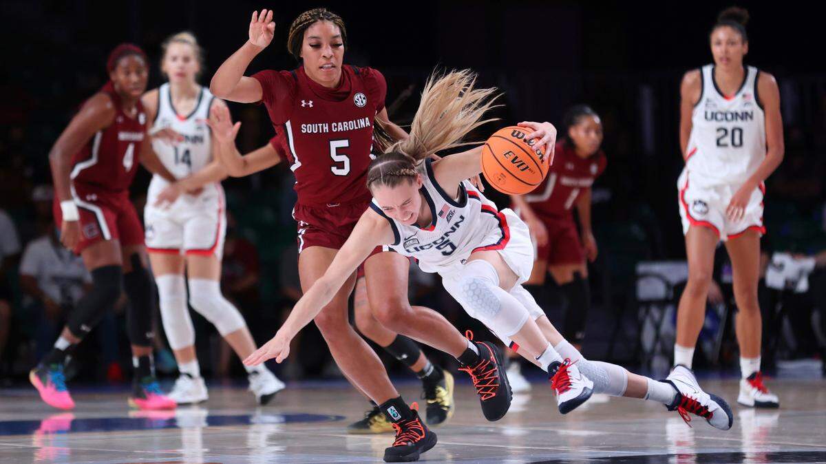 In this photo provided by Bahamas Visual Services, South Carolina forward Victaria Saxton (5) defends against UConn guard Paige Bueckers (5) during an NCAA college basketball game at Paradise Island, Bahamas, Monday, Nov. 22, 2021.
