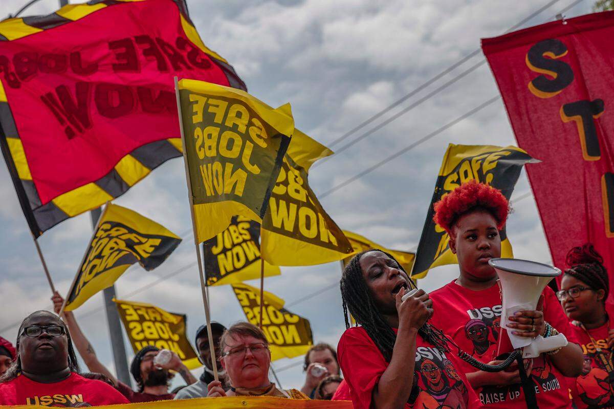 Audrey Williams, left, shares a story of safety concerns at Ryder warehouse where she works during a rally supporting fast food, retail and warehouse workers outside the Ryder warehouse in Columbia on Tuesday, April 04, 2023.