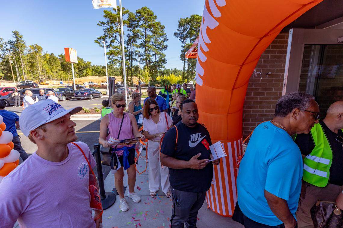 People wait in line to enter the Irmo Whataburger during the grand opening on Monday, Sept. 9, 2024.