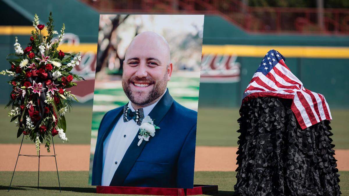 Photos of Ryan Fischer adorn the baseball field at Founders Park during the celebration of life service for Fischer held Wednesday.